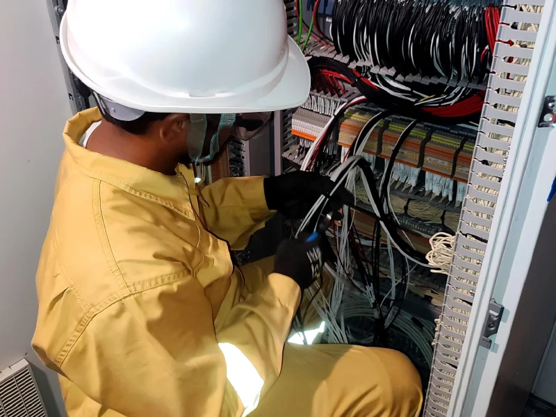 Engineer working on a control panel on site